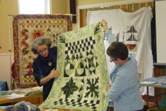 marianne-showing-one-of-her-sampler-quilts-with-debbie_8901691973_o